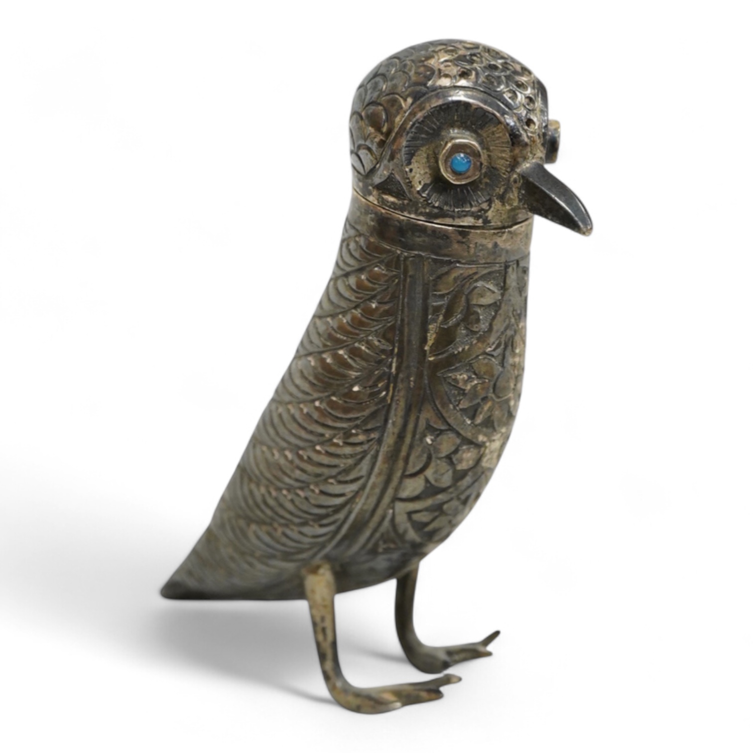 A novelty white metal pepperette, modelled as a free standing bird, with blue glass eyes, indistinct mark to one leg, height 87mm.